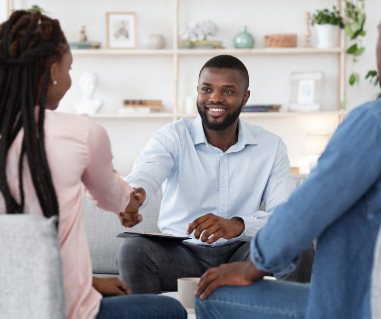 Family Counselor Shaking Hands With Happy Black Couple After Successful Therapy