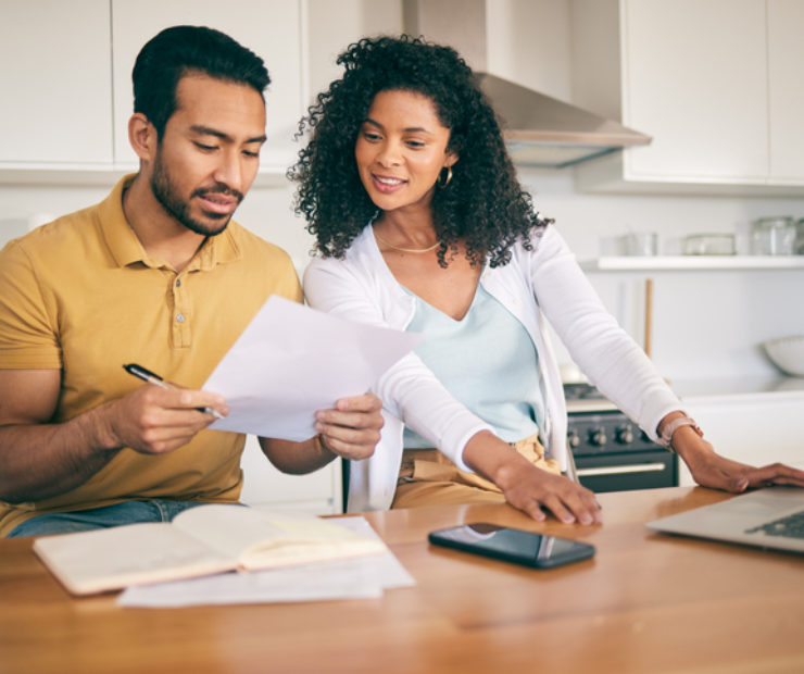 Couple, insurance paperwork and budget planning with laptop, bills and finance with taxes and mortgage. Financial documents, payment and loan with policy, audit and review with asset management